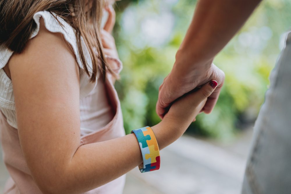 A parent holding a child’s hand